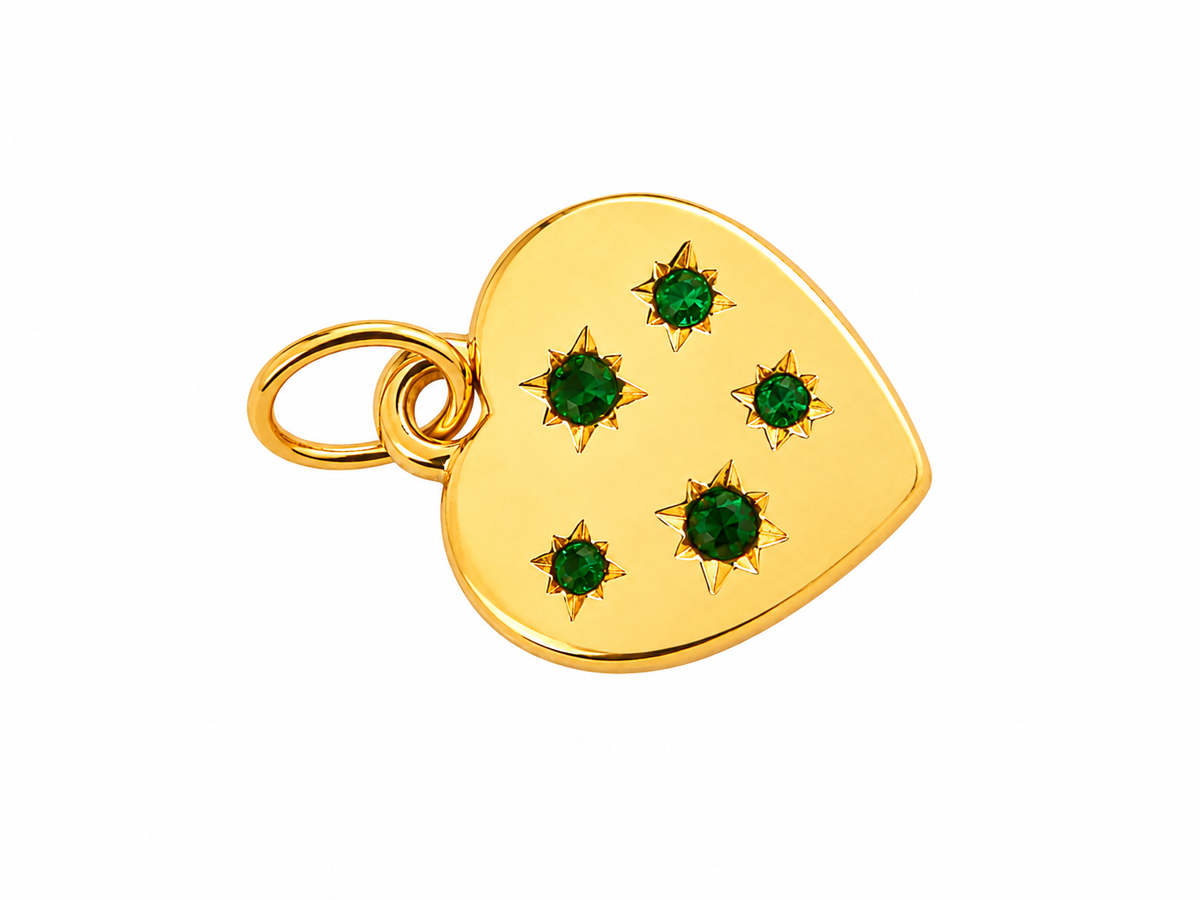 Corazón dorado con gemas verdes